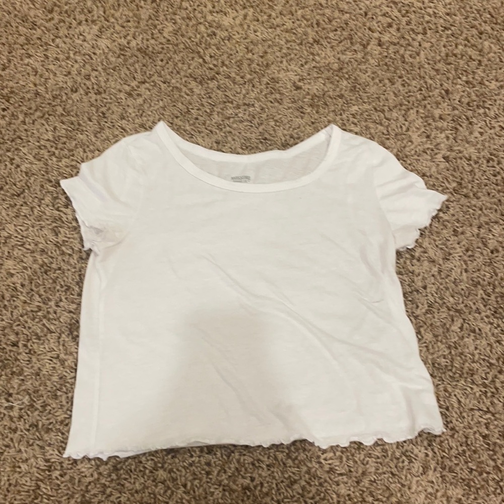 White crop top with a small stain.